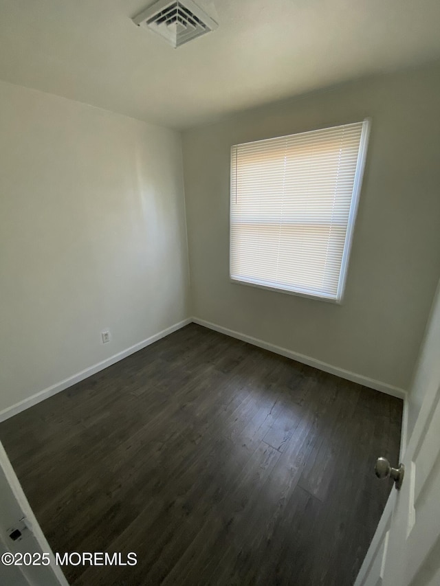 spare room with dark hardwood / wood-style flooring