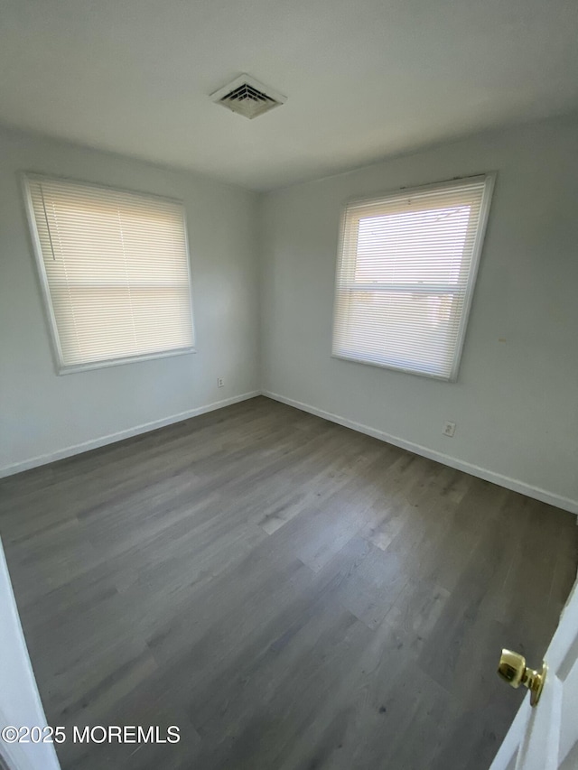 spare room with dark hardwood / wood-style floors