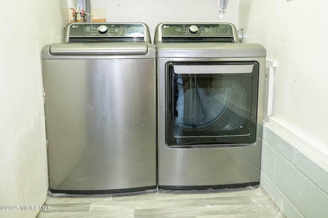 clothes washing area with washing machine and clothes dryer