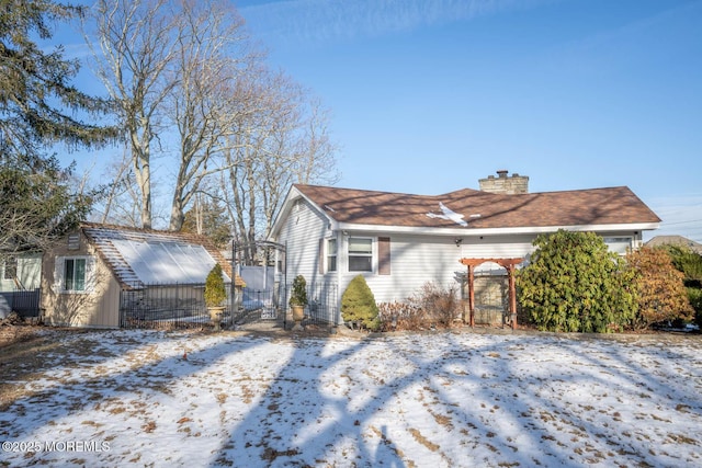 view of snowy exterior with an outdoor structure