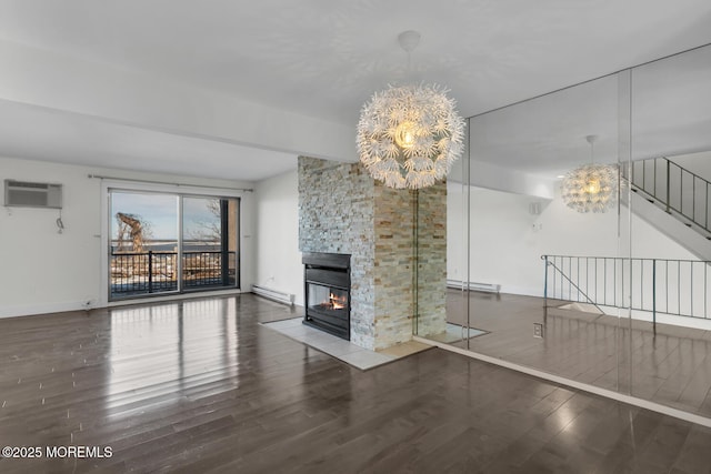 unfurnished living room with a fireplace, a baseboard radiator, and an inviting chandelier