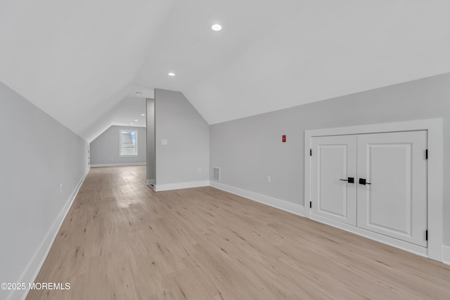 bonus room with light hardwood / wood-style floors and lofted ceiling