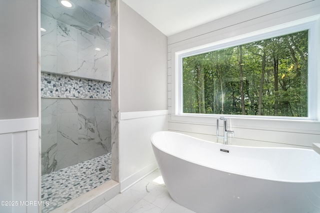 bathroom with a wealth of natural light and independent shower and bath