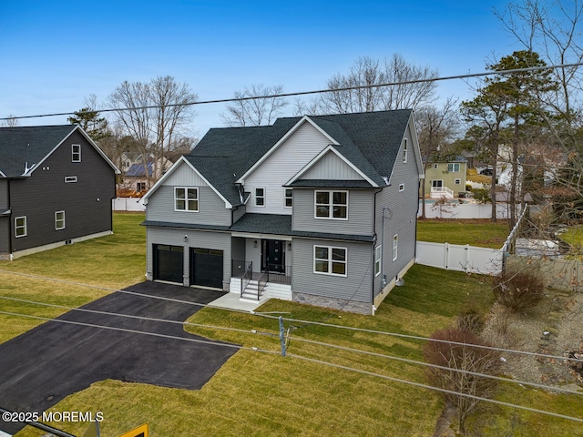 view of front of property featuring a front yard and a garage