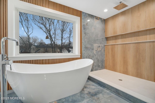 full bathroom featuring a soaking tub, a shower, and recessed lighting