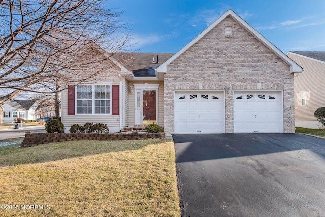 view of front of house with a front yard and a garage