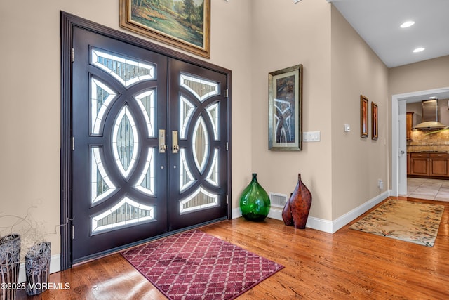 foyer with hardwood / wood-style floors and french doors