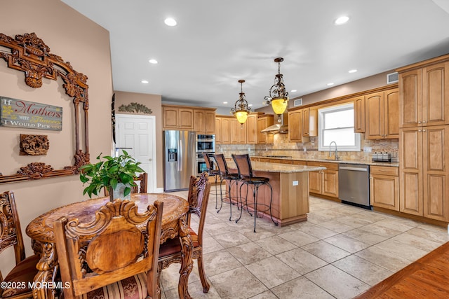 kitchen featuring light tile patterned flooring, decorative backsplash, decorative light fixtures, a kitchen island, and stainless steel appliances