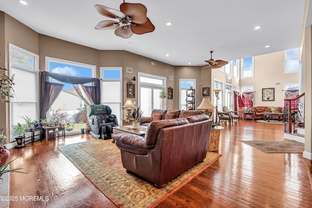 living room with hardwood / wood-style floors and ceiling fan