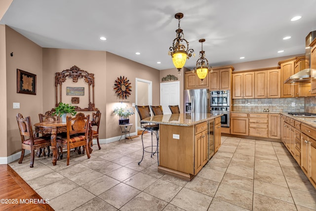 kitchen featuring light stone countertops, a center island, pendant lighting, a breakfast bar, and appliances with stainless steel finishes