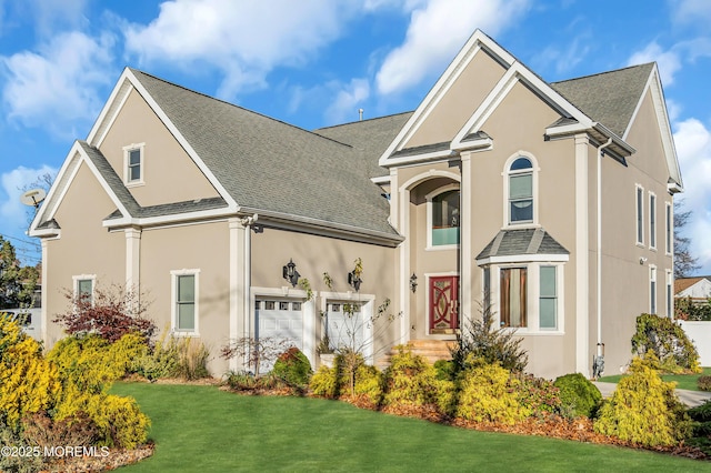 view of front facade featuring a front lawn and a garage