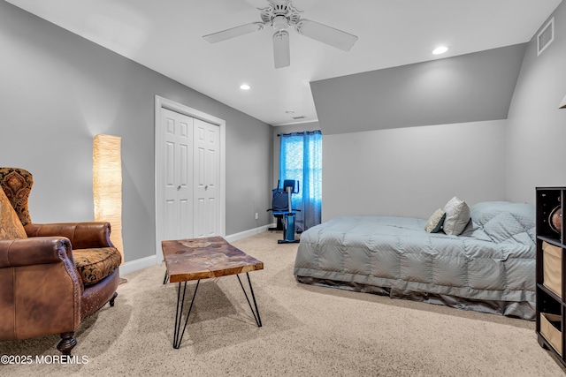 carpeted bedroom with ceiling fan and a closet