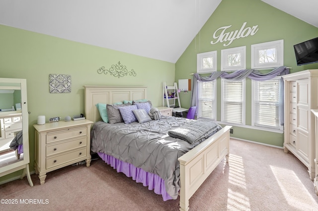 carpeted bedroom with high vaulted ceiling