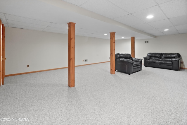 living room with carpet flooring and a paneled ceiling