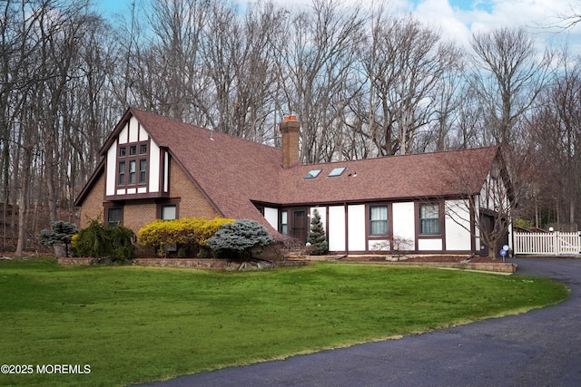 tudor house featuring a front yard