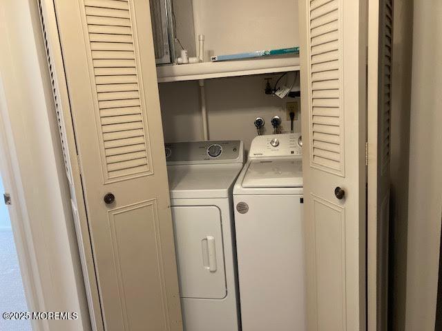 laundry room featuring washing machine and clothes dryer