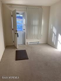 unfurnished room with light colored carpet