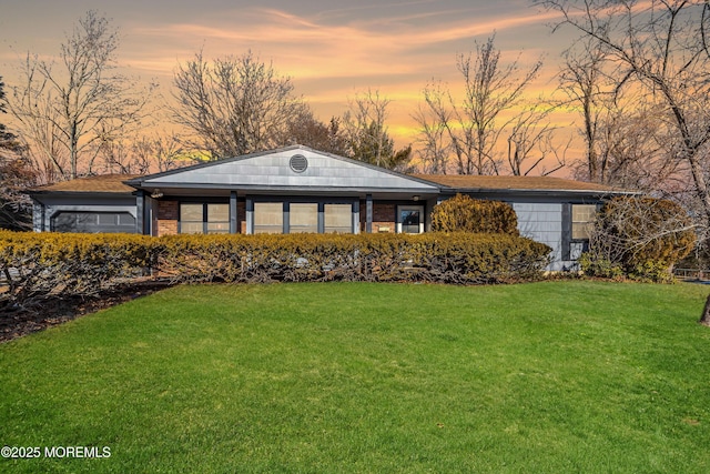 ranch-style home with a yard