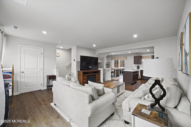 living room with dark hardwood / wood-style flooring