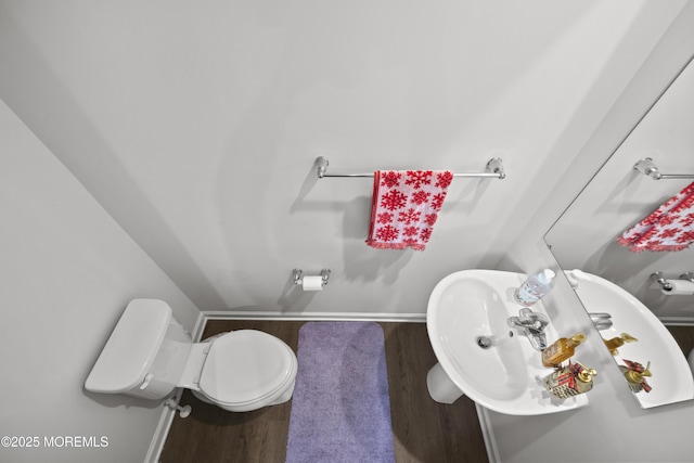 bathroom featuring sink, hardwood / wood-style floors, and toilet