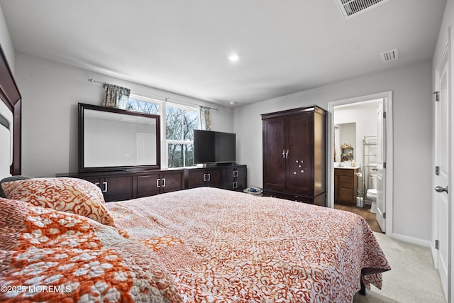 carpeted bedroom with ensuite bath