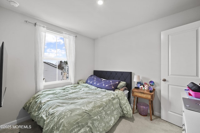 bedroom with light colored carpet