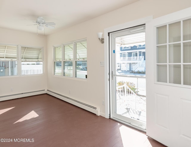 entryway featuring ceiling fan, dark hardwood / wood-style flooring, plenty of natural light, and a baseboard heating unit