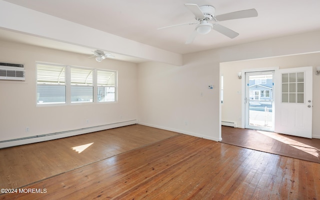 unfurnished room with wood-type flooring, a baseboard radiator, a wealth of natural light, and ceiling fan