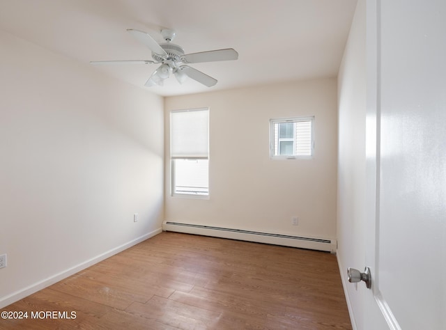 unfurnished room with ceiling fan, light hardwood / wood-style flooring, and a baseboard heating unit