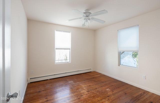 empty room featuring ceiling fan, dark hardwood / wood-style flooring, and a baseboard heating unit