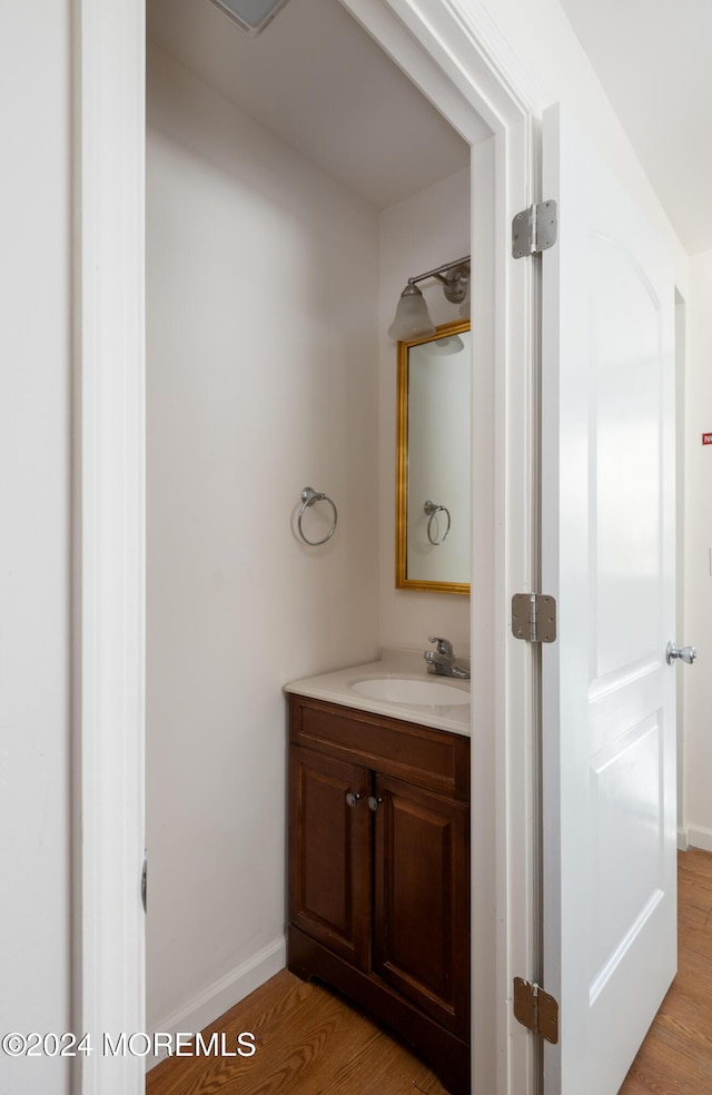 bathroom with vanity and hardwood / wood-style flooring