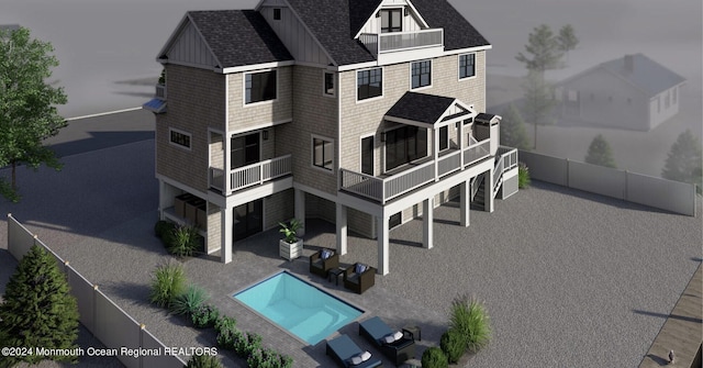 exterior space with a patio, a fenced in pool, and a balcony