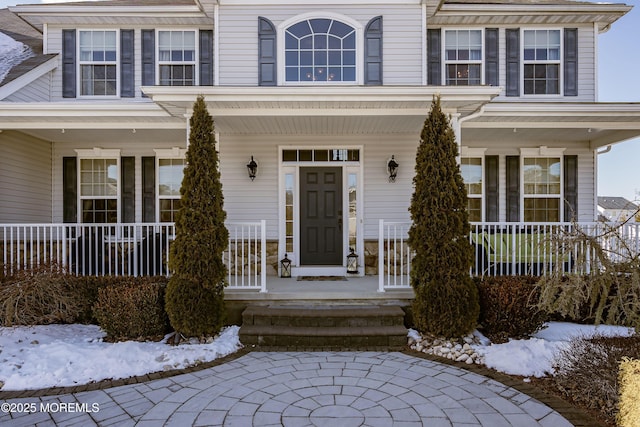 view of snow covered property entrance