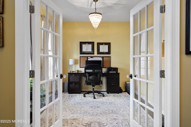 office featuring french doors and a notable chandelier