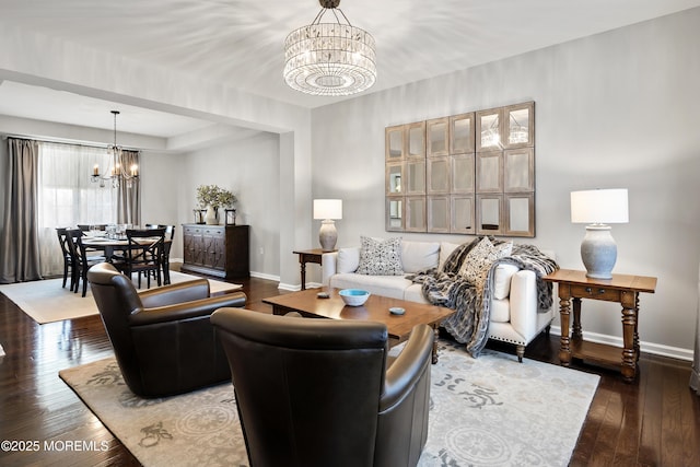 living room with baseboards, a chandelier, and dark wood-style flooring