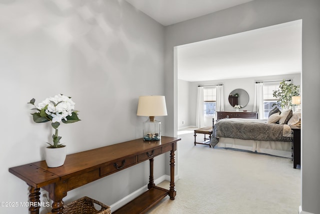 carpeted bedroom featuring baseboards