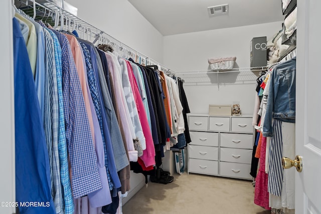 spacious closet with visible vents and light colored carpet