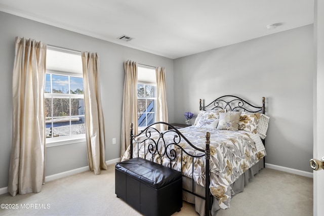 bedroom featuring carpet, multiple windows, visible vents, and baseboards