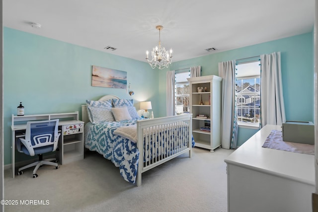 carpeted bedroom with an inviting chandelier