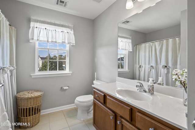 bathroom featuring tile patterned floors, vanity, and toilet