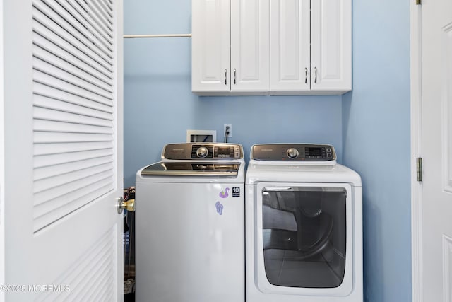 laundry room with separate washer and dryer and cabinet space