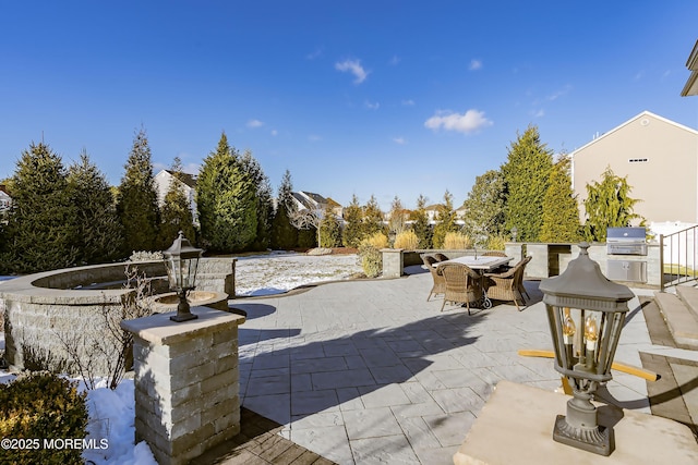 view of patio featuring grilling area and exterior kitchen