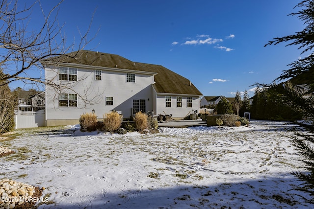 view of snow covered back of property