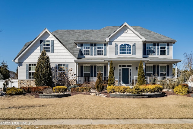 view of front of property with stone siding and a porch