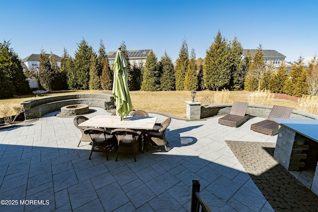 view of patio / terrace with a fire pit and outdoor dining space