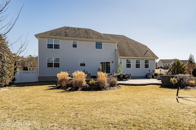 rear view of house featuring a patio area, fence, and a yard