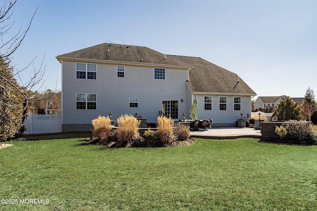 back of house featuring a lawn, a patio area, and fence