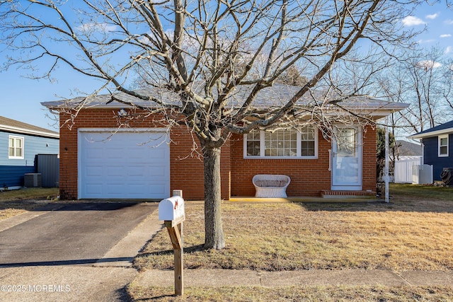 view of front of house with a garage and central air condition unit