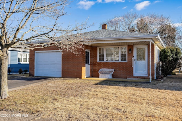 ranch-style home with a garage and a front lawn