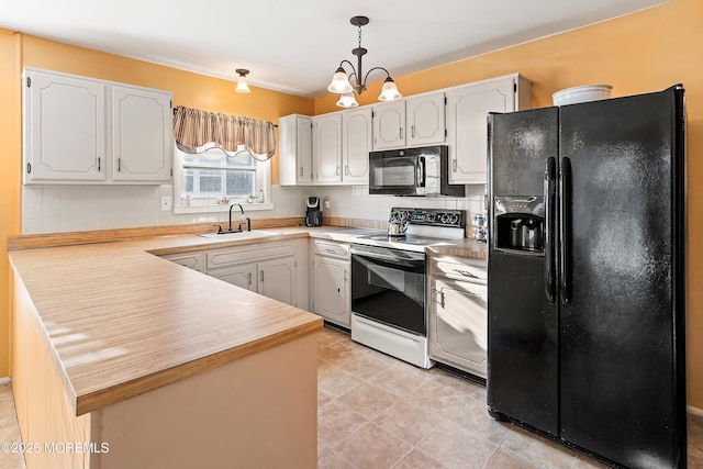 kitchen with hanging light fixtures, white cabinets, black appliances, and kitchen peninsula